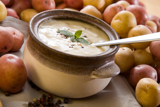 Creamy potato soup garnished with mint leaves