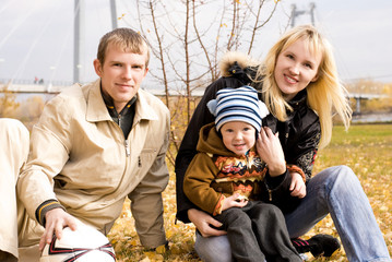 happy smiling family with a football ball outdoor
