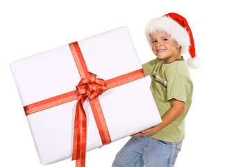 Happy boy with christmas hat and big present - isolated
