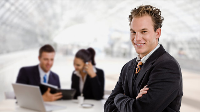Business team working at office lobby, smiling businessman