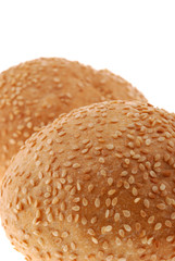 bun for sandwich. A bakery product strewed by grains