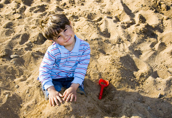 boy playing in the sand