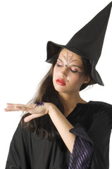 pretty girl with witch hat and a spider on her hand