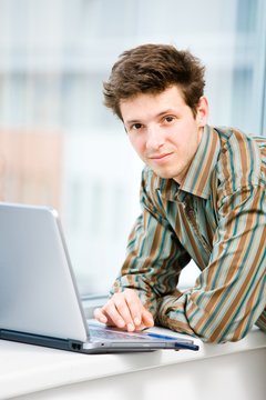 Casual looking businessman working on laptop computer
