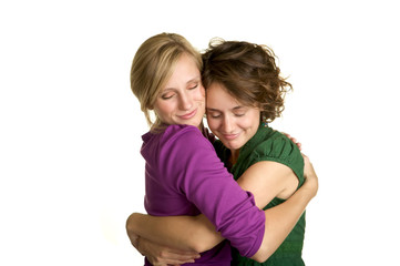 Fototapeta na wymiar Two sisters giving each other a warm hug