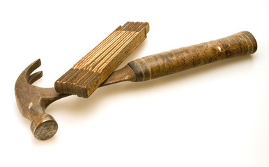 Old hammer and tape measure used for construction