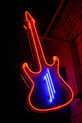 red neon guitar with blue strings