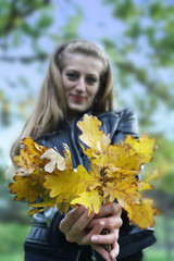 the beautiful girl presents the autumn bouquet