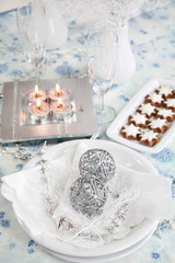 Christmas table setting in white and silver tone