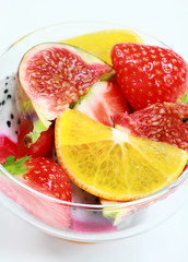 Fototapeta na wymiar Delicious fresh fruits in bowl as dessert