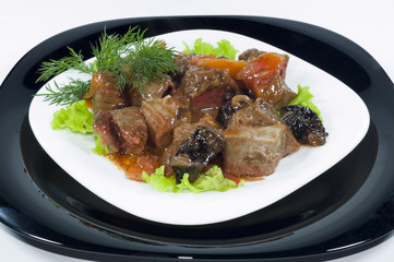 Meat of the rabbit on a black and white plates isolated