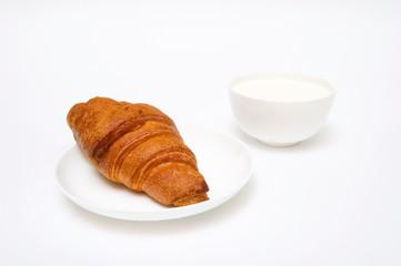 Croissant and milk isolated on white