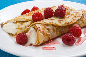 Pancakes with cream and raspberries