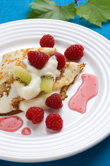 Pancakes with cream and raspberries