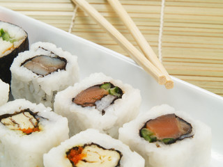 Close up of sushi with chopsticks