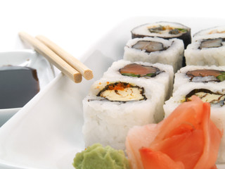 Sushi with chopsticks on white
