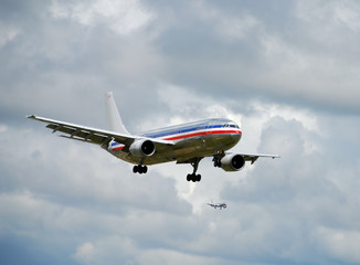 Fototapeta na wymiar SIlver colored passenger jet airplane landing