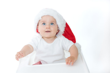 little, cute baby boy wearing Christmas hat, on white
