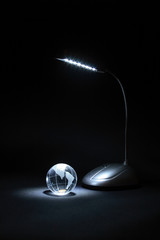 Little glassy globe and luminose table lamp
