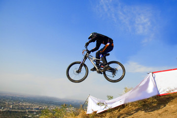 Fototapeta na wymiar Biker jump in mountains, Competition