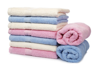 Multicolored towels stacked with soft shadow on white background