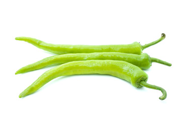 Three yellow-green chili peppers isolated on the white