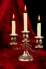 candlestick with three candles and reflection