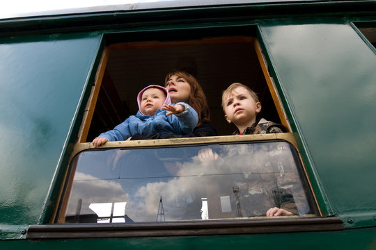 Family Looking Out Of Window