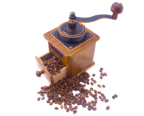 Coffee grinder and scattered grains of coffee