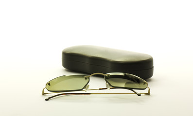 Eyeglass and black cover on white background