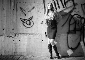 Young woman on graffiti wall background. Black and white.