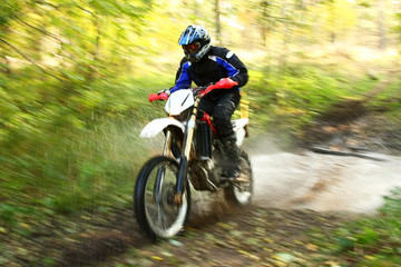 Fototapeta premium Offroad motorbike crossing river, water splashing. Motion blur.