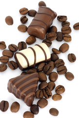 Coffe beans and chocolate candies on white background
