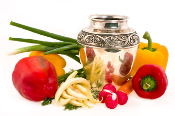 Vegetables and silver jug on a white background