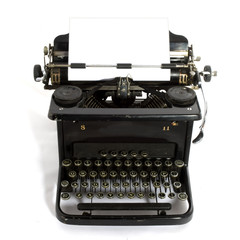 black old-fashioned typewriter with white paper for your text