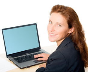 Portrait of charming woman sitting in front of laptop
