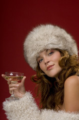Beautiful lady with fur hat toasting with champagne