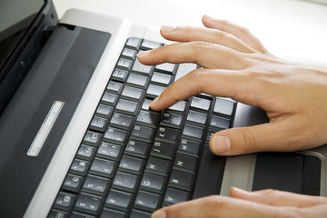 Image of businesswoman’s hands working on the laptop