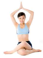 Obraz premium An attractive young woman sitting on floor in a yoga pose