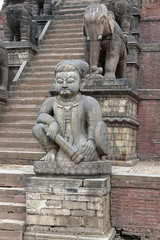 Fototapeta na wymiar Statues on the steps of a Hindu Temple in Nepal