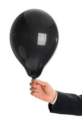 Person holding a black balloon isolated on white