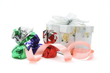 Gift Box and Chocolate Lollies on White Background