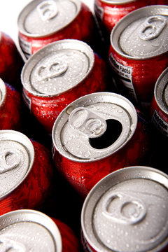 Cans of ice cold red soda pop in aluminum cans