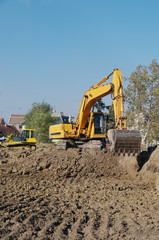 Working  with excavator on yellow  ground