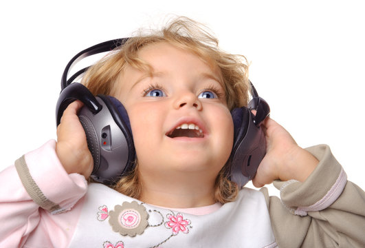 Child wearing headphone and listening the music