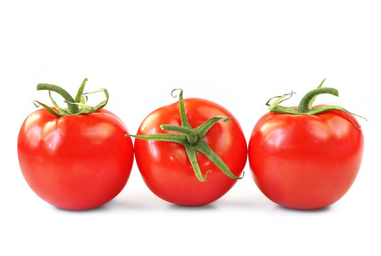 Three vine ripened truss tomatoes, isolated on white.