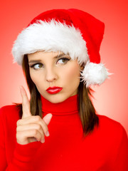 beautiful woman wearing santa claus hat on red background