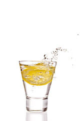 Lemon splashing in glass isolated on white background