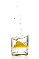 Lemon splashing in glass isolated on white background