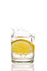 Lemon splashing in glas isolated on white background